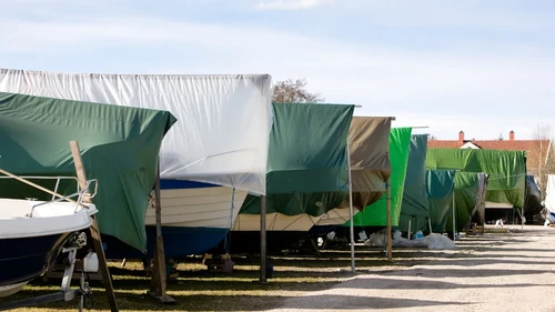 Boat parking with tarps covering various boats